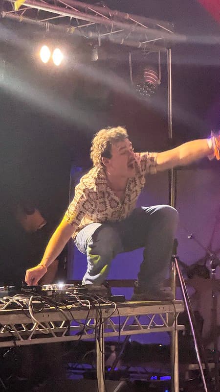 Woody Cook stood on the mixing table twiddling the knobs on the mixer
